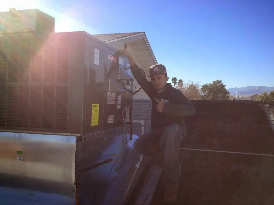HVAC technician performing HVAC Inspection on a rooftop unit in Franklin Park